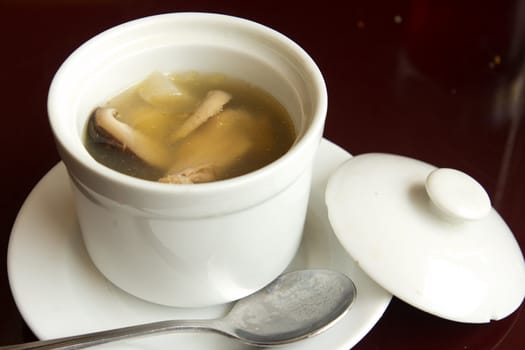 Abalone chicken mushroom soup in a white bowl ready to serve