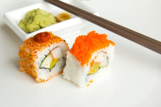 Two Japanese sushi isolated on a white plate