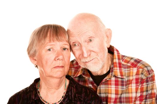 Portrait of concerned senior couple on white background