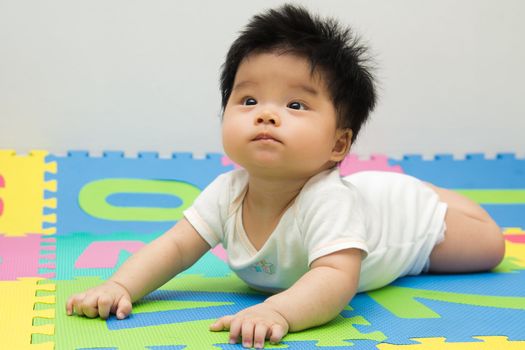 Portrait of a little Asian baby girl crawling on floor