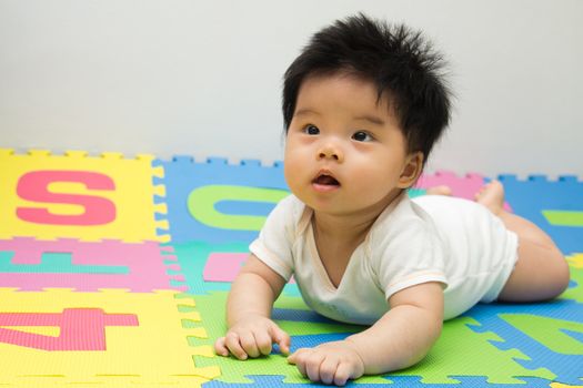 Portrait of a little Asian baby girl crawling on floor