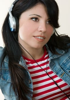 Female listening to music through headphones.