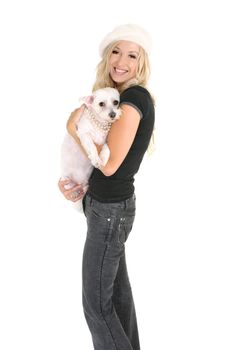 Smiling woman carrying a small white dog in her arms.