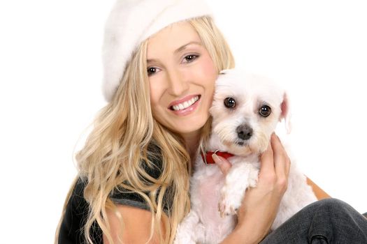 A sitting female hugging a small white dog