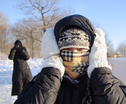 Cold winter woman covering herself from the cold.