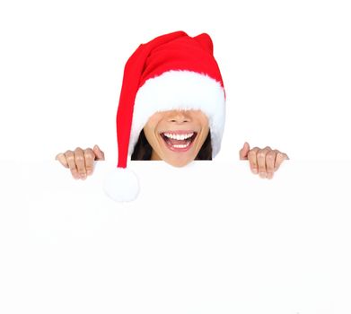 Funny christmas woman with billboard sign. Woman with too big santa hat standing behind billboard with funny expression. Isolated on white background.