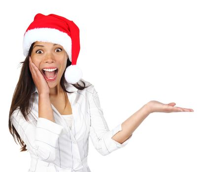  Santa girl presenting your product with christmas hat. Beautiful young mixed asian / caucasian woman isolated on white.