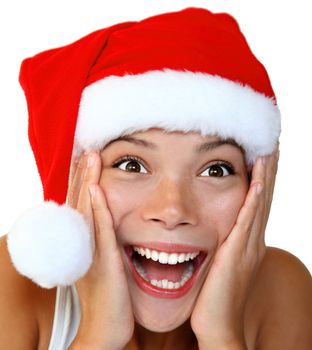  Christmas woman in a Santa hat very surprised and excited. Isolated on white background.