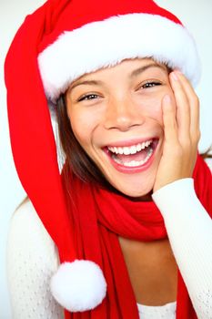 Christmas woman in a Santa hat very surprised and excited. Isolated on white background.