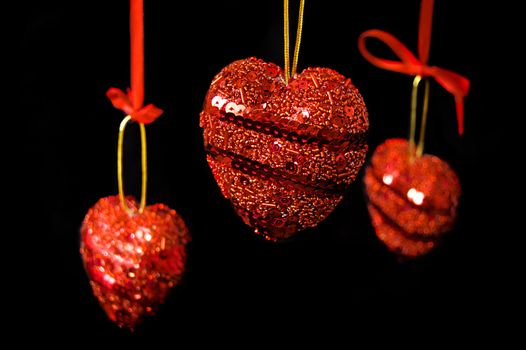 Christmas red hearts hanging over black