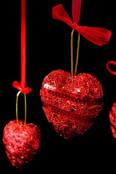Christmas red hearts hanging over black