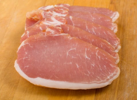 close-up fresh pork on wooden cutting board