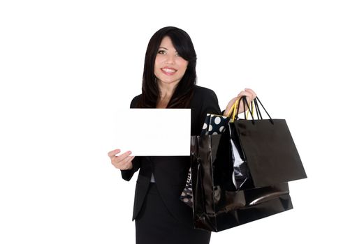 A female holding some boutique shopping bags and a blank sign or message