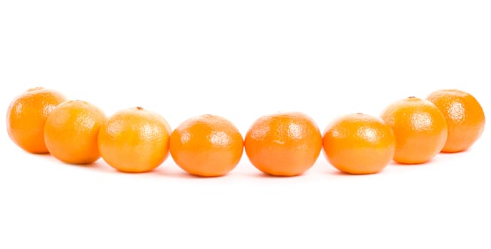 line of fresh tangerines, isolated on white