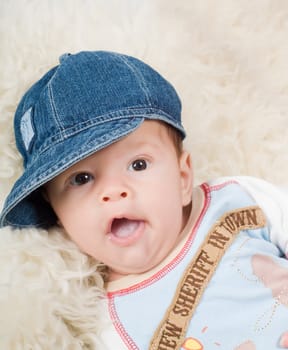 Shot of trendy newborn boy in denim cap