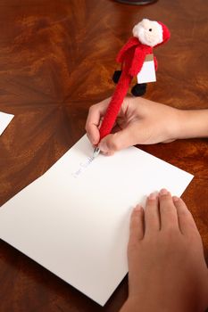 Closeup of a child writing out a letter to santa