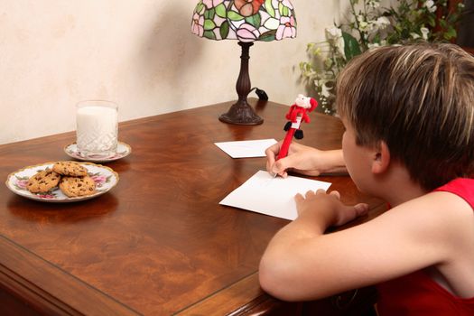 A child sitting at a desk writing a letter