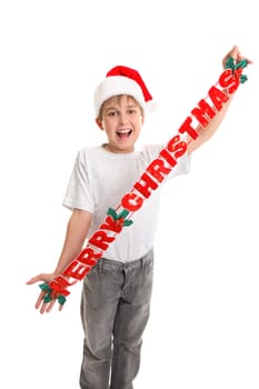 A child holding a Christmas  decoration that says Merry Christmas