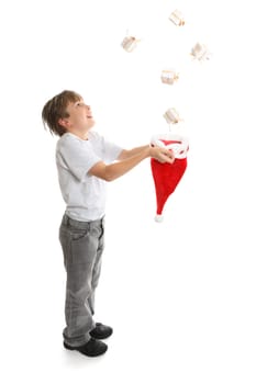 Gifts galore.   An excited  full length boy catches Christmas presents falling from above.