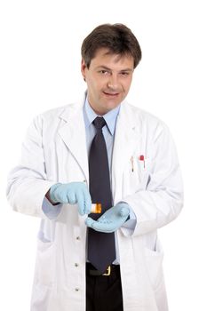 A doctor or veterinarian tipping pills into his hand from a prescription bottle.