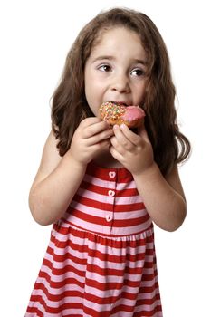 Young girl eating a pink iced doughnut.