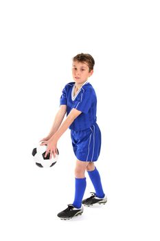 A boy plays with a soccer ball.