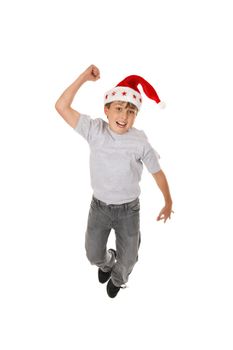 An excited boy leaps for joy at Christmas