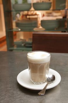 Cafe Latte Coffee on a Saucer with Teaspoon