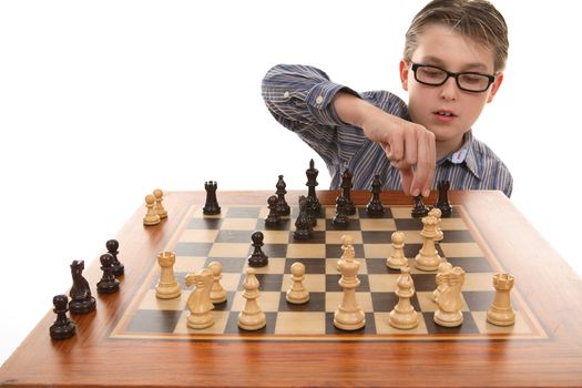A boy moving a chess piece on a portable chess game table.
