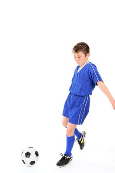 Child running and kicking a soccer ball.   Motion in legs.
