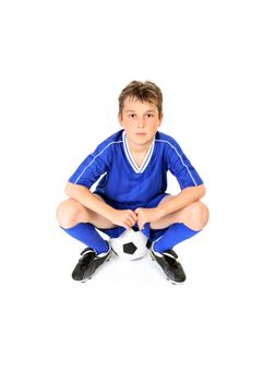 Soccer player resting on soccer ball.