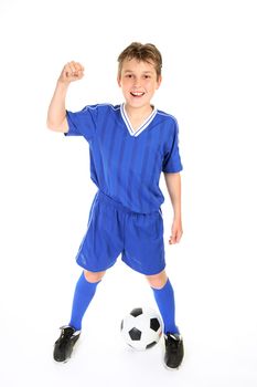 A boy in soccer jersey and shorts with fists in victory
