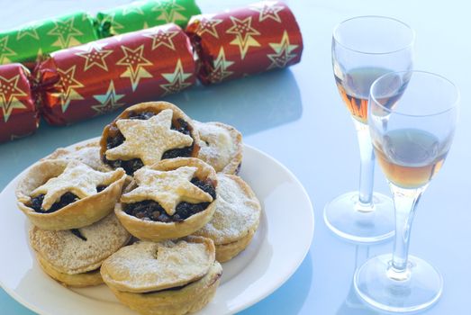 a Christmas still life with mince pies, glasses of sherry and crackers