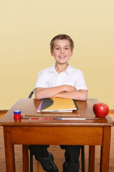 School boy sitting up straight in class