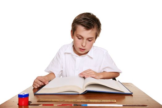 A school child reading a book or studying