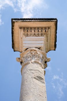 Ancient marble column against the blue sky. Rome, Italy