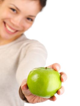 Green apple. Beautiful autumn woman giving you an apple. Isolated on white background. Shallow depth of field, focus on the apple