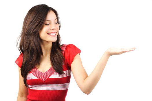 Woman showing product .Beautiful casual young woman holding out her hand, presenting your product. Isolated on white background.