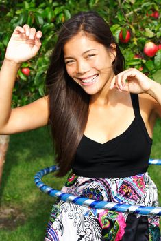  Hula hoop. Very beautiful young woman doing hula hoop outdoors in late summer. 
