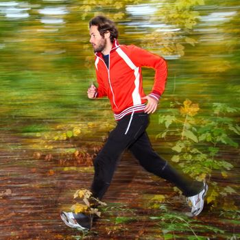  Man running in autumn forest.
