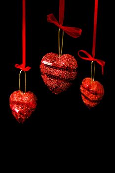Christmas red hearts hanging on black