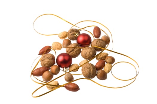 Arrangement of christmas decoration and different nuts isolated against white background.