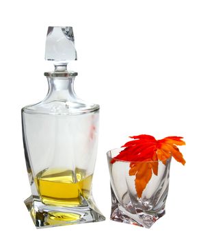 Crystal bottle and glass with light whisky and maple leaf