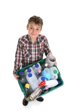 Boy carrying a recycling container full of empty bottles, cans, etc suitable for recycling.