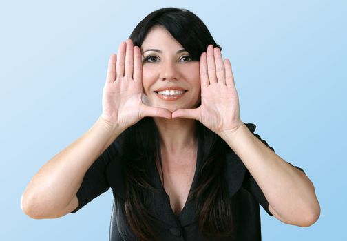 A woman with hands framing the face