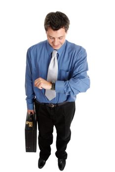 Businessman holding a briefcase checks the time