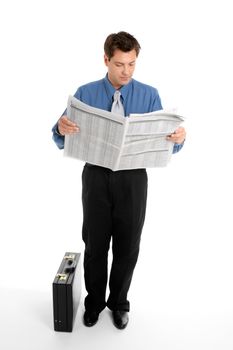 A businessman reads the finance newspaper while waiting for bus, train, taxi.  Newsprint has been blurred.