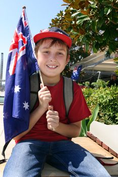 Young patriotic smiling boy holding an Australian flag