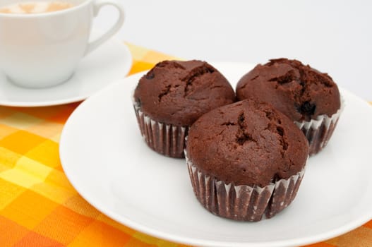 Chocolate Muffins and Coffee on Orange Tablecloth