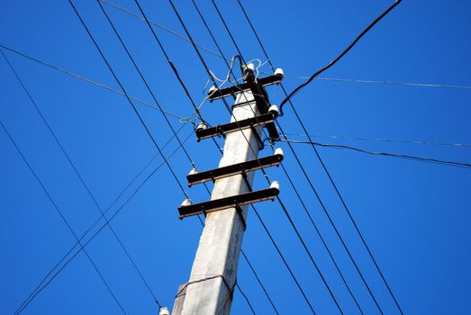 Electricity and Communication Post with Wires on Sky Background